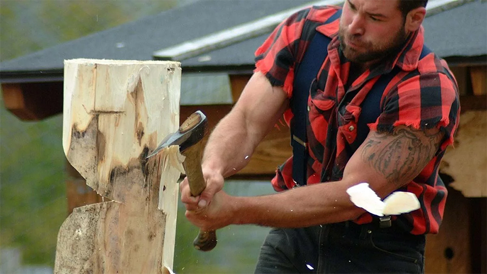 strong lumberjack chopping the wood