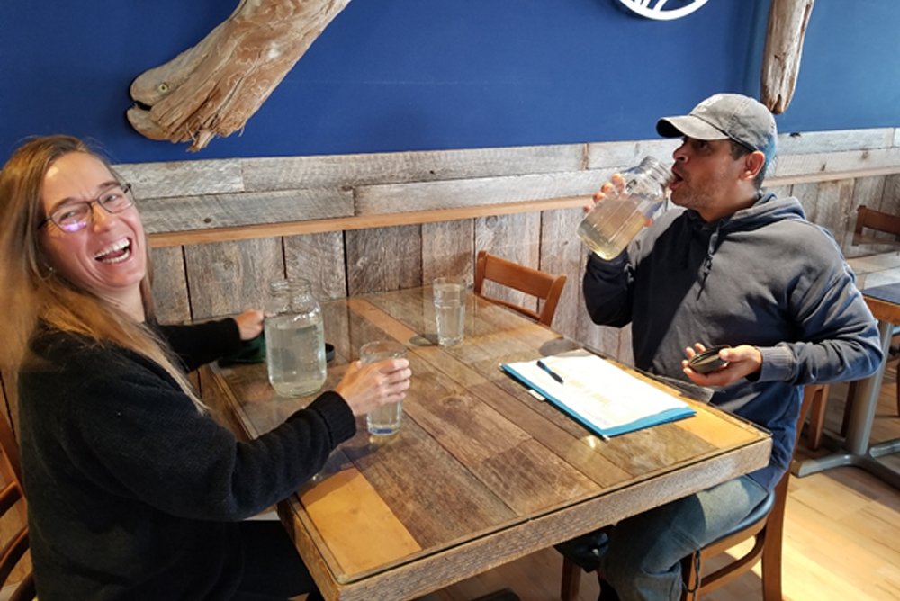 happy couple sitting on the table drinking water